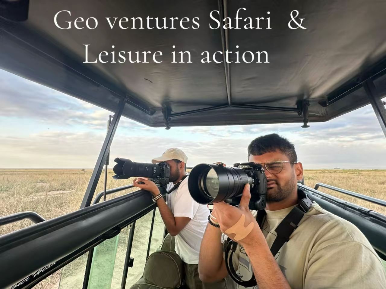 Photographers shooting from an open safari vehicle on the savanna